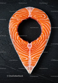 Fresh salmon steak on dark textured surface