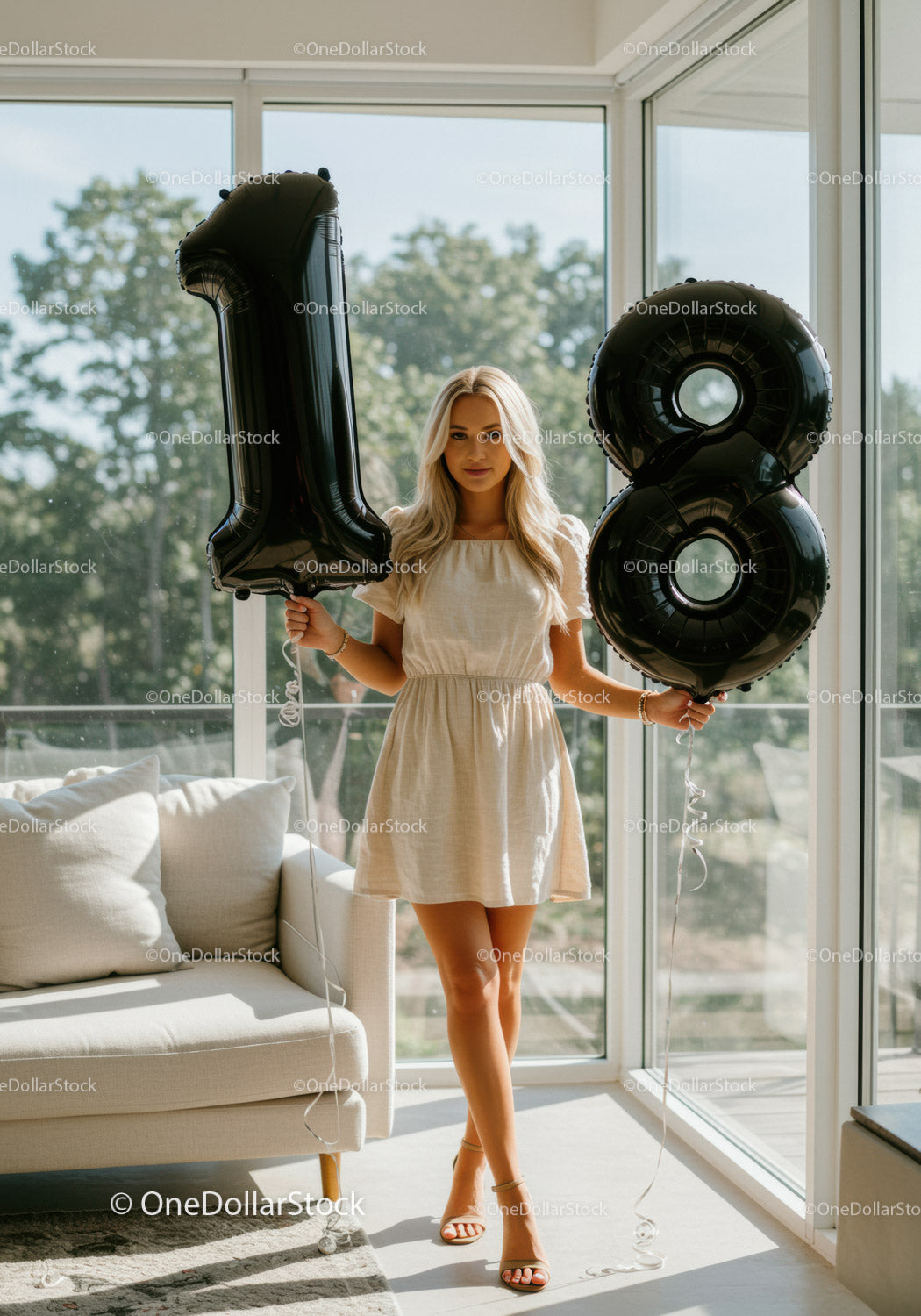 Young woman celebrating 18th birthday with black balloons