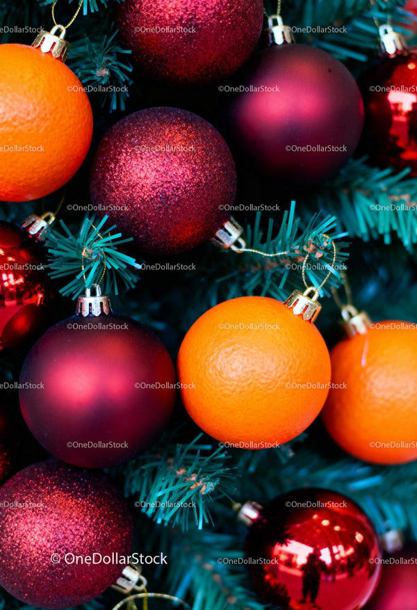 Christmas tree decorated with red baubles and fresh oranges