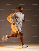 Focused man running indoors in athletic wear