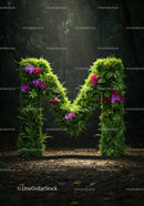 Green Letter M Covered with Leaves and Flowers in Forest