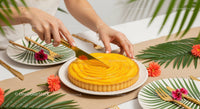 Woman Slicing Lemon Tart on Tropical Decorated Table for Summer Party