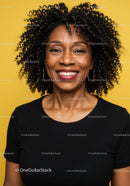 Joyful Black Woman with Curly Hair Smiling Portrait Against Yellow Background