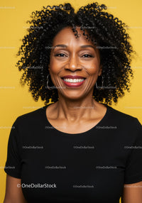 Joyful Black Woman with Curly Hair Smiling Portrait Against Yellow Background