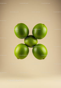 Fresh green limes arranged in circular formation on beige