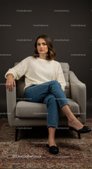 Woman Sitting in a Modern Interior Studio with a Relaxed Pose