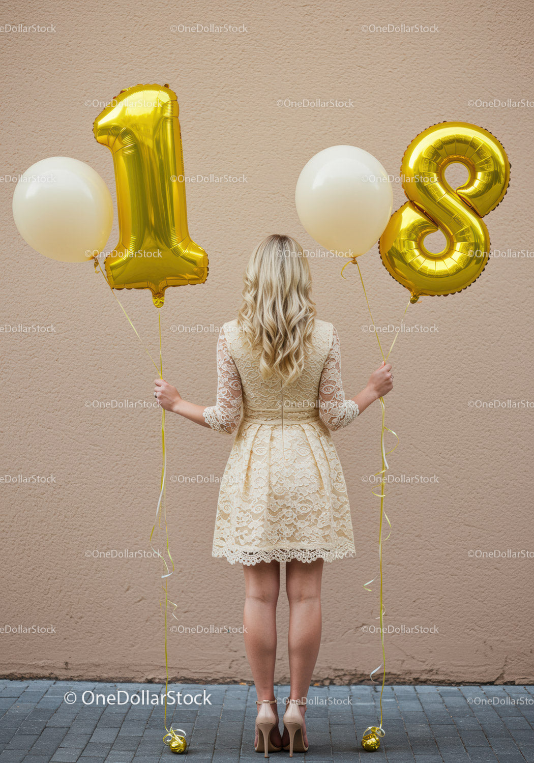 Young woman in lace dress holding 18th birthday balloons