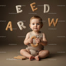 Baby Playing with Soft Alphabet Toys on Neutral Background