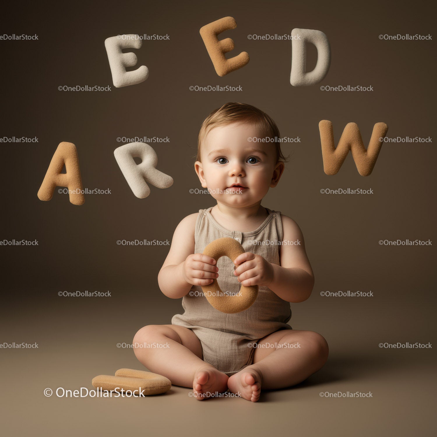 Baby Playing with Soft Alphabet Toys on Neutral Background
