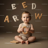 Baby Playing with Soft Alphabet Toys on Neutral Background