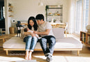 Young Parents Embracing Their Newborn at Home