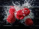 Fresh Red Raspberries Splashing into Water in Close-Up