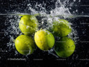 Green Apples Splashing into Water with Dynamic Movement