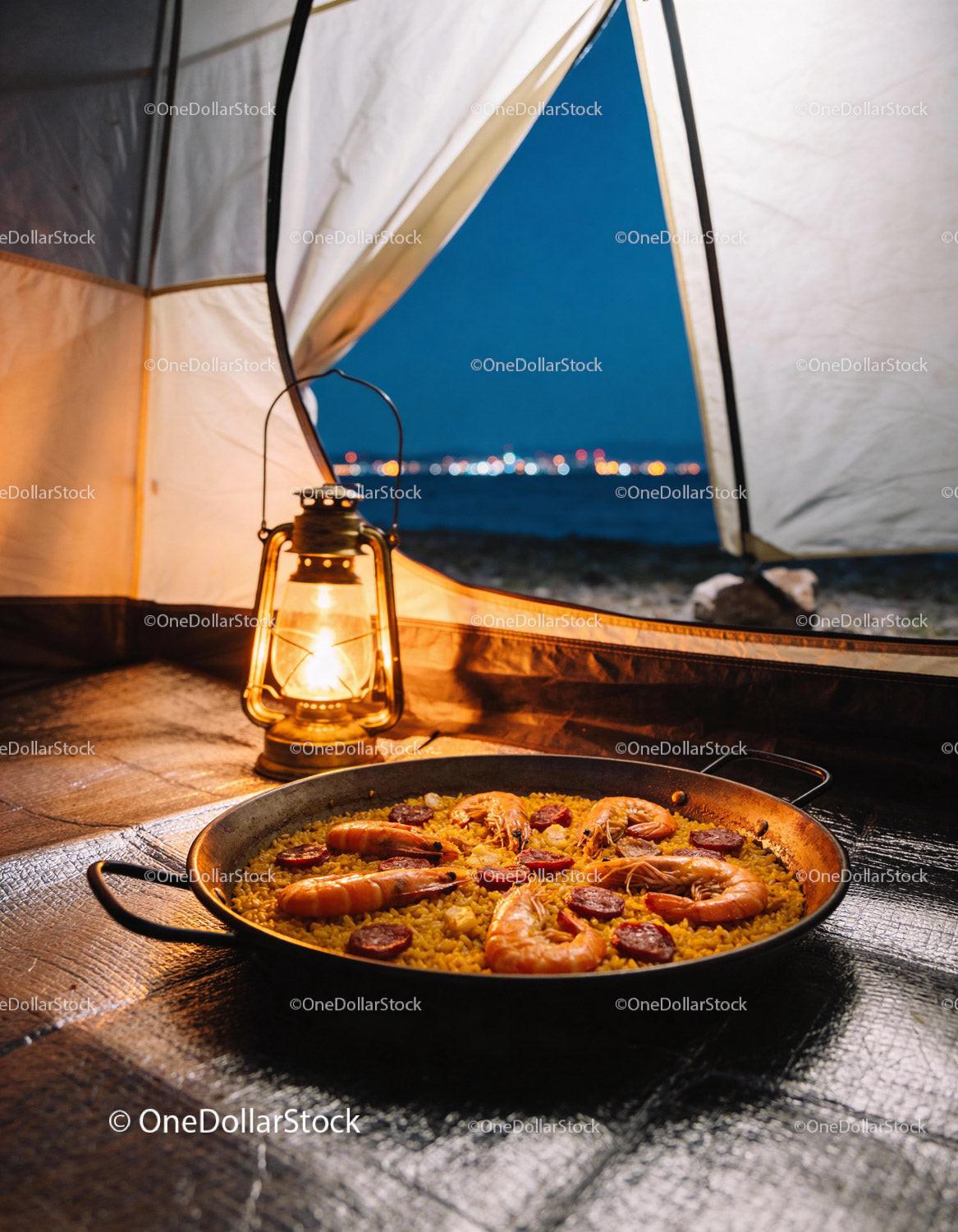Seafood paella enjoyed inside a cozy campsite at night
