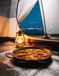 Seafood paella enjoyed inside a cozy campsite at night