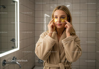 Young Woman Applying Under Eye Patches During Skincare Routine
