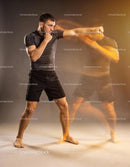 Man practicing fast boxing punches with motion blur