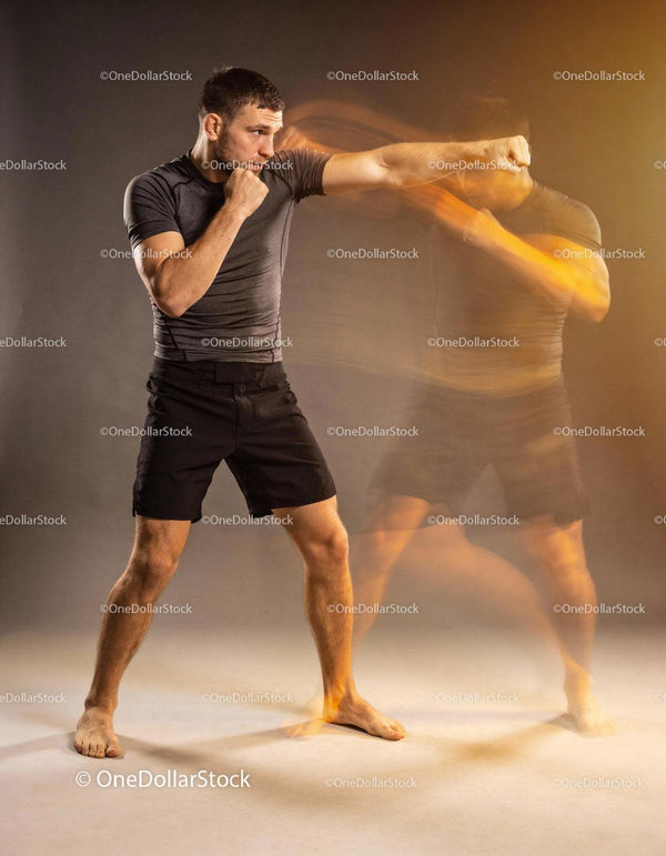 Man practicing fast boxing punches with motion blur