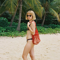 Woman in Bikini with Red Tote Bag on Tropical Beach with Palm Trees