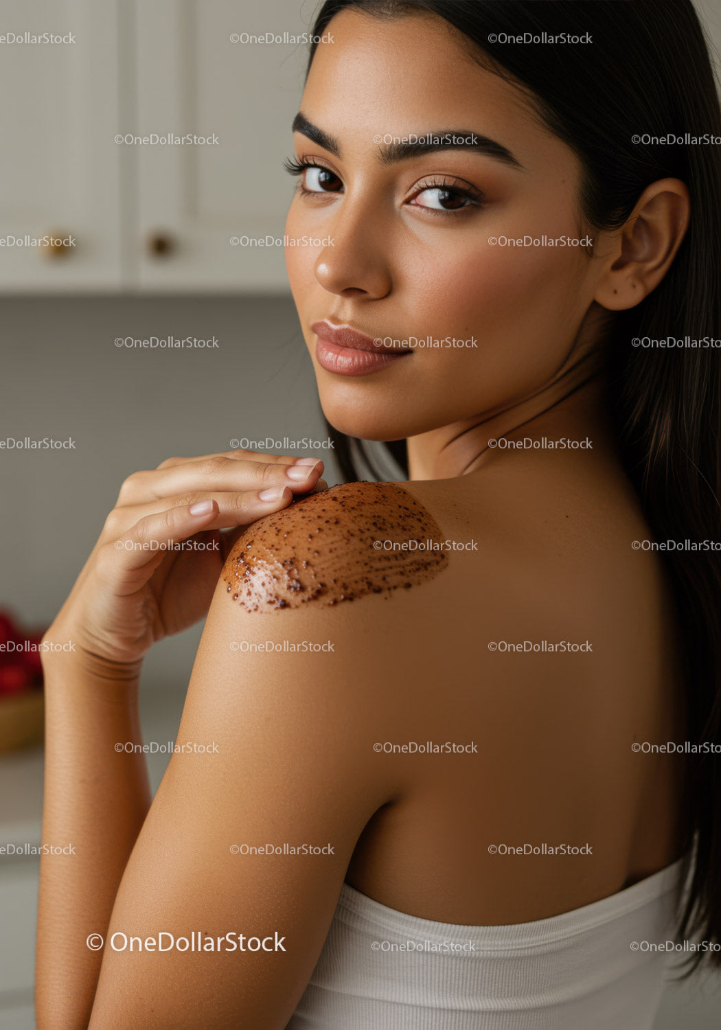 Young Woman with Long Dark Hair Applying Chocolate Body Scrub