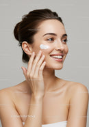 Young Woman Applying Face Cream for Glowing Skin