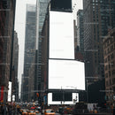 Busy urban street with blank large digital billboards
