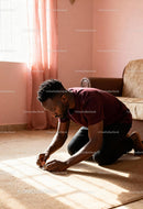 Young man concentrating on puzzle on sunlit carpet