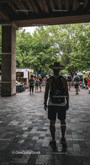 Traveler with Hat Exploring Vibrant Outdoor Market
