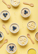 Healthy oatmeal bowls with fresh blueberries and bananas