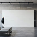 Businesswoman Walking Past Large White Wall in Gallery