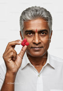 Elegant Mature Indian Man Enjoying Raspberries with Healthy Lifestyle
