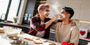 Joyful LGBTQ Couple Baking Heart-Shaped Cookies Together