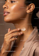 Close-Up of Woman Applying Skincare Moisturizer on Face and Neck