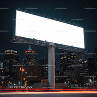 Empty Illuminated Billboard over City Skyline at Night
