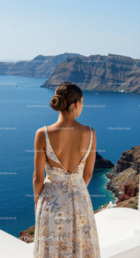 Woman in floral dress admiring sea view from cliff