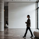 Businesswoman walking past minimalist modern gallery space