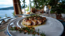 Gourmet Seared Tuna Steak with Herbs on White Plate by the Sea