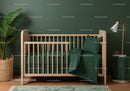 Green Baby Crib with Cozy Bedding in Modern Nursery