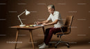 Senior Man Concentrating While Writing in Modern Workspace