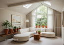 Bright modern living room with curved sofa and plants