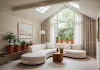 Bright modern living room with curved sofa and plants