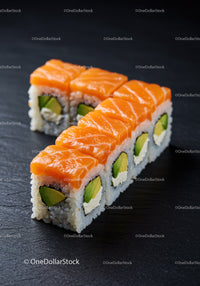 Fresh Salmon and Avocado Sushi Rolls on Black Slate