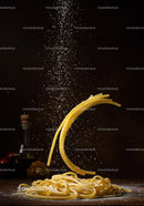 Falling flour dust over fresh Italian pasta on wooden table