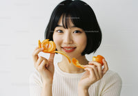 Young Woman Enjoying Fresh Mandarin Slices Smiling Brightly