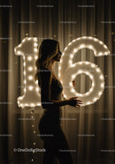 Silhouette of Woman Holding Illuminated 16 Balloon