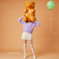 Woman Wearing Gummy Bear Head with Green Balloon
