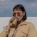 Young Woman Drinking Yellow Smoothie in Casual Summer Outfit