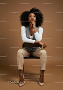 Stylish Confident Woman Sitting on Chair in Modern Studio