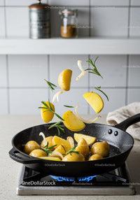 Sautéing Potatoes with Onions and Fresh Rosemary in Pan