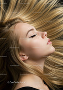 Blonde woman with flowing hair and serene expression
